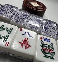 Close-up of Mahjong tiles showing Chinese characters, numbers, and the '4 WIN' tile with colorful inlays.