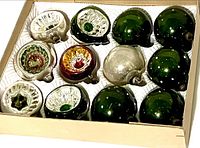 Close-up showing assorted glass ornaments including six with indents in silver, red, and green, plus smooth green and silver ball ornaments.