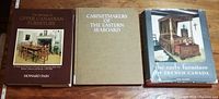 Three hardcover books titled 'The Heritage of Upper Canadian Furniture,' 'Cabinetmakers of the Eastern Seaboard,' and 'The Early Furniture of French Canada' arranged on a wooden surface.