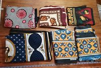 Six folded East African fabrics showing vibrant colors and patterns