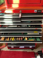 Middle drawer with assorted hammers including claw hammer and mallet