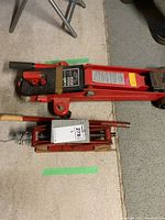 Top-down view of hydraulic trolley jack and scissor jack showing overall condition and size comparison.