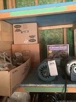 Shelf with multiple electric motors, some boxed items including a framing system box and a box of metal hooks