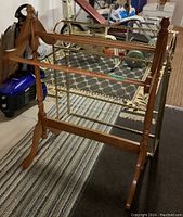 Wood quilt rack with light finish, turned wood design and horizontal bars for hanging quilts or towels