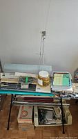 Full view of knitting machine and accessories on table