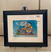 Full view of framed artwork on folding stand, showing overall presentation and frame condition