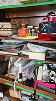 Shelves filled with assorted sewing items such as boxes, ribbons, thread bobbins, pin cushions, and small packages.