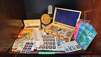 Overview showing all items: pen set, stamps, plate, pin box, lanyard, Collect packs