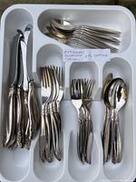 Full set of 24 pieces displayed in a white plastic tray: 8 knives, 8 dinner forks, 4 salad forks, 4 tablespoons all with matching Lailani pattern handles.