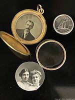 Open locket showing one black and white portrait photo inside along with removable glass pane and a Canadian dime for scale