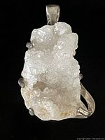 Front view of large white quartz mounted in prong setting with natural crystal texture and sparkle.