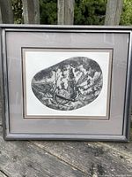 Framed black and white art print with grey mats and original frame outdoors.