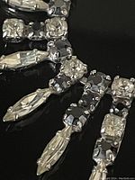 Close-up of front section showing marquise and round clear rhinestones hand-set in silver-tone metal