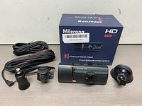 Full set including main dash cam unit, rear and inside cameras, power adapter, and product box.