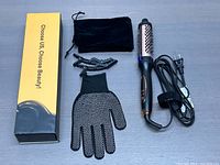 Full lot overview showing curling iron brush, glove, clips, storage pouch, and box on a flat surface