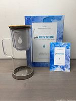 Full set including glass pitcher with handle, bamboo lid, filter reservoir with multiple filters inside, original box and user manual.