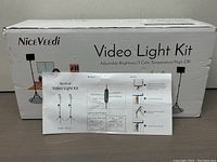 Box and instruction manual of the Niceveedi Video Light Kit with printed specifications and setup.