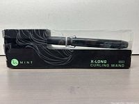 Packaged Mint X-Long Curling Wand with black box featuring product name and branding.