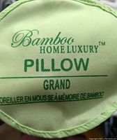 Close up of pillow cover label showing Bamboo Home Luxury Pillow Grand with bamboo memory foam text.