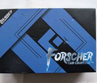 Box packaging featuring FORSCHER LED Lighting brand with black and blue design