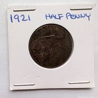Front side of the 1921 half penny coin showing the coin's design and handwritten year and denomination on the holder.