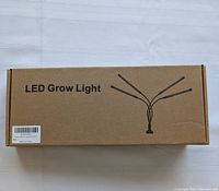 Cardboard retail box labeled 'LED Grow Light' showing a sketch of the grow light with three adjustable arms.