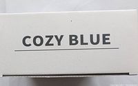 Close-up photo of the Cozy Blue brand name on the product box.