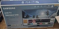 Sealed Samsung UHD TV box showing 55" screen size and 6 Series MU6290 model