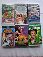 Front covers of six VHS movie cases showing titles and cover art.