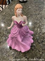 Front view of Royal Doulton Victoria figurine wearing a pink gown