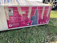 Packaging of the artificial Christmas tree showing brand, height, and LED feature.