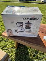 Closed box of Babymoov Nutribaby showing packaging with baby food maker image and branding