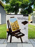Photo of boxed Artist's Studio Italian easel kit showing 33-piece included painting set and folded easel