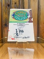 Photo of the front cover of the "Charlie and the Chocolate Factory" paperback book showing the title, author, and illustrations.