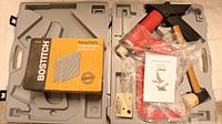 Entire kit with air stapler, flooring staples box, wooden hammer, and accessories in carrying case.