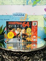Front view of Fighting Force 64 Nintendo 64 game box with promotional sticker.