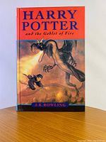 Front cover showing title and cover illustration of dragon breathing fire at Harry Potter.