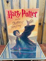 Front cover of Harry Potter and the Deathly Hallows with artwork of Harry casting a spell.