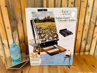 Box of Artist's Studio Italian Easel showing the packaging and the 34-piece set contents.