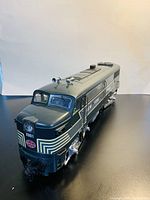 Front angled view of the dark green and cream Aristo Craft Railway Express Agency Diesel Locomotive with number 2001 and New York markings.