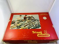 Original red box with a cover image showing children playing with the railway set, labeled Tri-ang Railways Electric Model Railway.