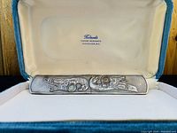 Bookmark presented inside credit-lined blue and cream case marked 'Forbanks Diamond Merchants Vancouver, B.C.' showing full front design.