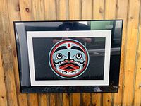 Framed limited edition print "Magwaboy" by Gary Peterson showing full front view with bold traditional West Coast Indigenous art style face design in black, turquoise, red and white colors.