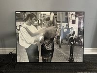 Frontal view of framed black and white photographic print showing the full image and frame, emphasizing details and overall condition.