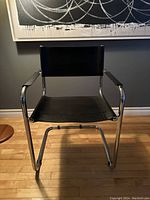 Front view of cantilever chair showing chrome frame and leather seat