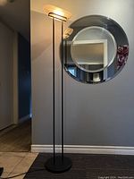 Full view of the lamp with circular mirror in background