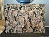 Front view of vintage textile artwork showing numerous Balinese women in traditional clothing, mounted on board.
