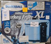 Photo of Butterball Indoor Electric Turkey Fryer XL box indicating new, never used condition, suitable for turkeys up to 20 lbs, includes gloves, injector and cooking recipe CD.