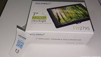 Box of Feelworld 7-inch Ultra Bright Daylight Viewable Field Monitor, showing front with model FW279S and 2200 nit brightness.