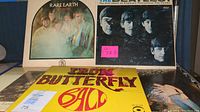 Photo showing upfront the Rare Earth 'Get Ready' and The Beatles 'Meet the Beatles!' vinyl album covers with a partial view of Iron Butterfly and other records beneath.
